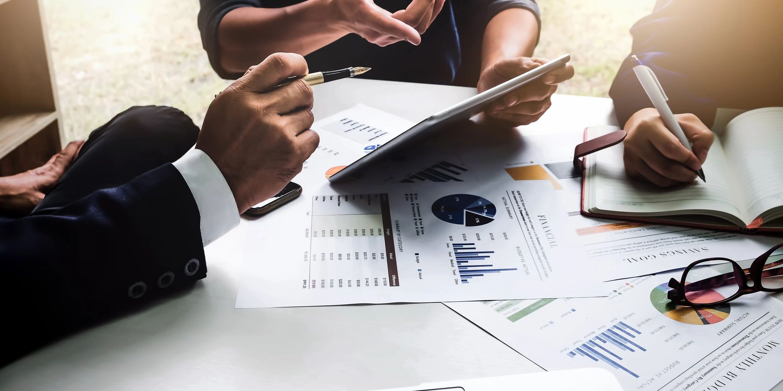 Business people using pen,tablet,notebook are planning a marketing plan to improve the quality of their sales in the future. (Business people using pen,tablet,notebook are planning a marketing plan to improve the quality of their sales in the future.,